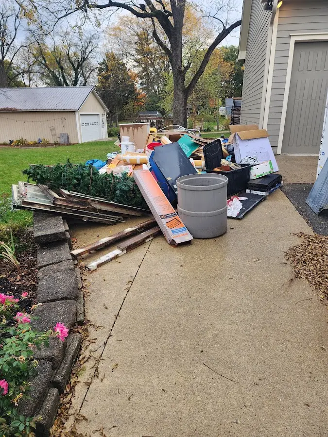 Dumpster being loaded with debris for Estate Cleanout Dumpster Rental in Upper Freehold